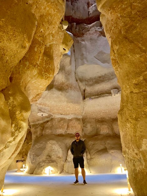 Foto ein mann in voller länge steht in einer höhle