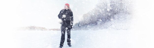 Ein Mann reist mit einem Rucksack. Winterwanderung im Wald. Tourist auf einem Spaziergang im Winter im Park.