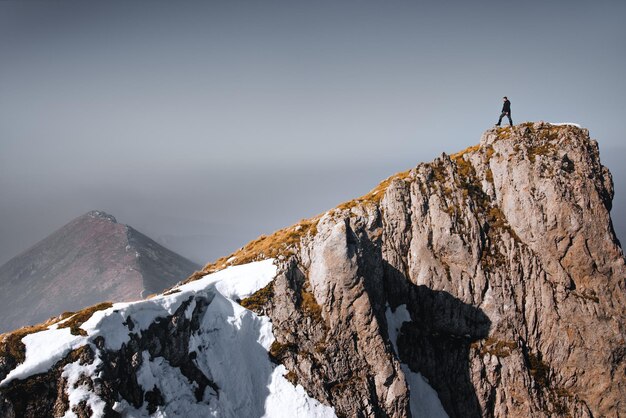 Foto ein mann steht auf einem felsen gegen den himmel