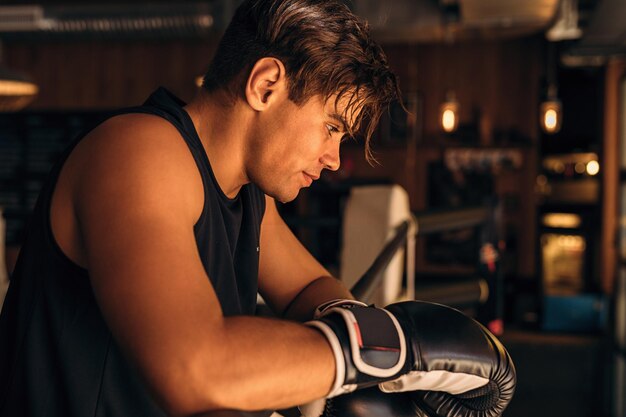 Ein nachdenklicher Mann mit Boxhandschuhen