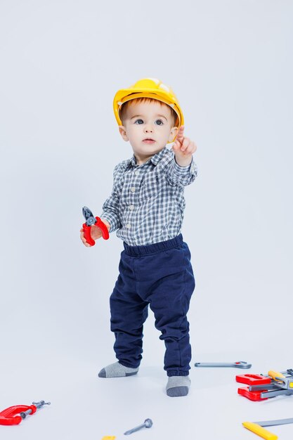 Ein netter Junge in einem T-Shirt in das Bild eines Baumeisters auf weißem Hintergrund Kindheit Lernen Arbeit Spiele Karriere Nachahmung Little Daddy's Helper