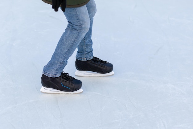 Ein Paar Hockeyschlittschuhe mit Schnürsenkeln auf gefrorener Eisbahn in der Nähe. Eislaufen oder Hockey spielen