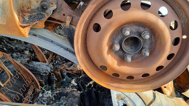 Foto ein rad eines fahrzeugs mit verrosteten metallteilen und verrosteten felgen.