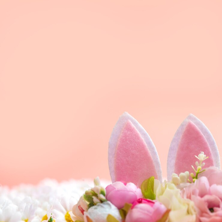 Foto ein rosa hintergrund mit hasenohren, die aus ihm herausragen.