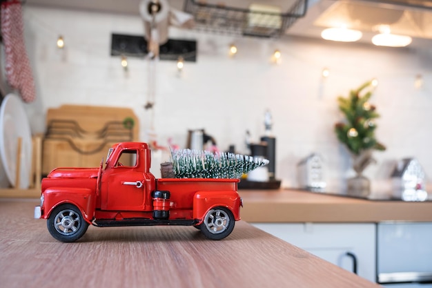 Ein rotes Retro-Auto mit Weihnachtsbaum schmückt die festliche Küche für weihnachtliche Wohnkultur festliche Stimmung im neuen Jahr