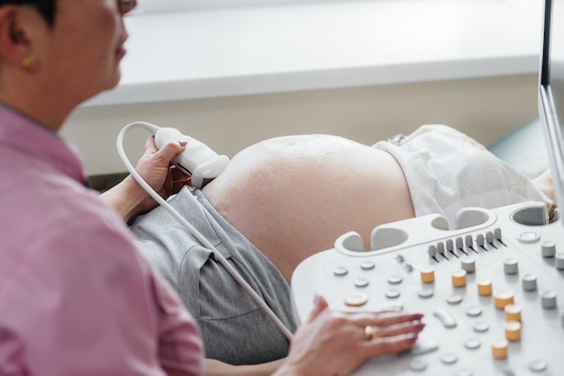 Ein schwangeres Mädchen hat in der Klinik einen Ultraschall des Bauches