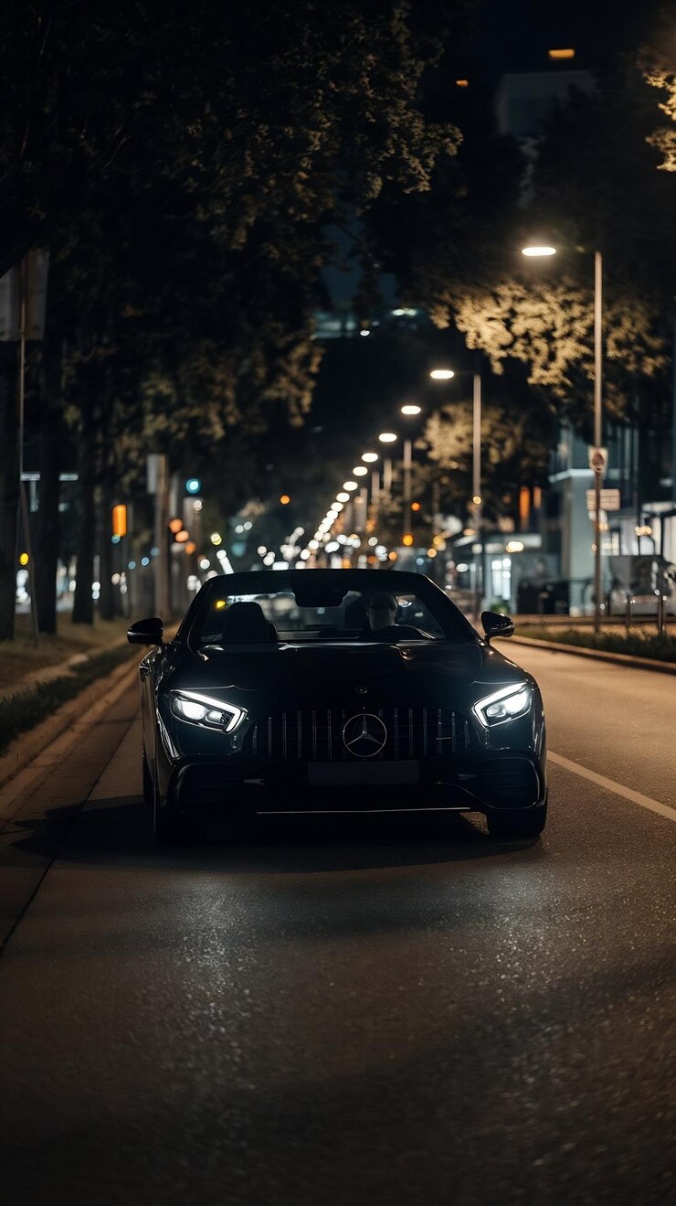 Foto ein schwarzes mercedes-benz fährt nachts auf einer stadtstraße