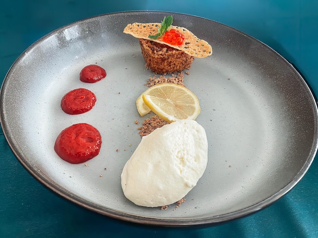 Ein Teller mit Essen mit Zitrone und Erdbeere darauf