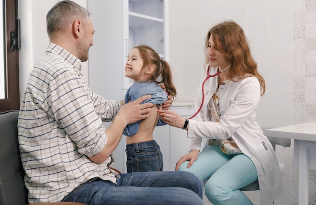 Ein Vater mit seiner kleinen Tochter bei einem Empfang mit einem Kinderarzt in der Klinik