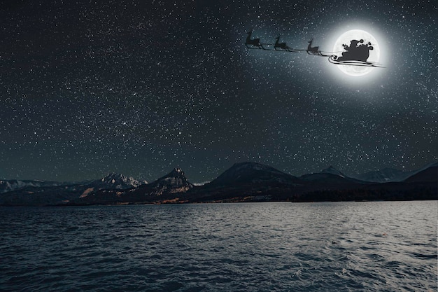 Foto ein weihnachtsmann fliegt am heiligabend gegen den hintergrund des mondes