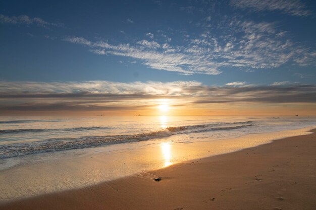 Ein wunderschöner Sonnenuntergang am Strand von Mazagon Spanien Am Ufer einige Muscheln