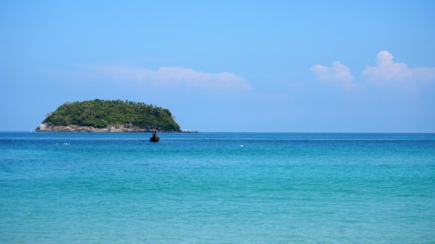 Eine einsame Insel im Meer Ein Boot schwimmt in der Nähe