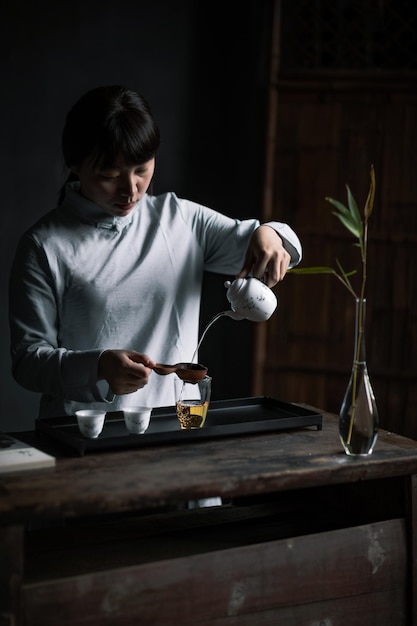Eine Frau gießt Tee in ein Glas