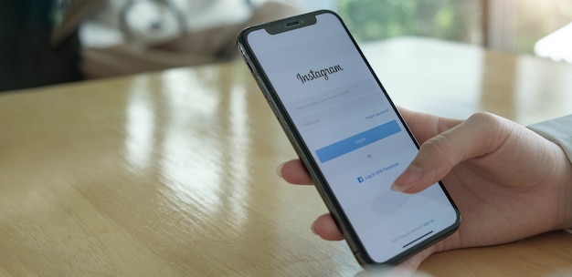 Eine Frau hält Smartphone mit Instagram-Anwendung auf dem Bildschirm