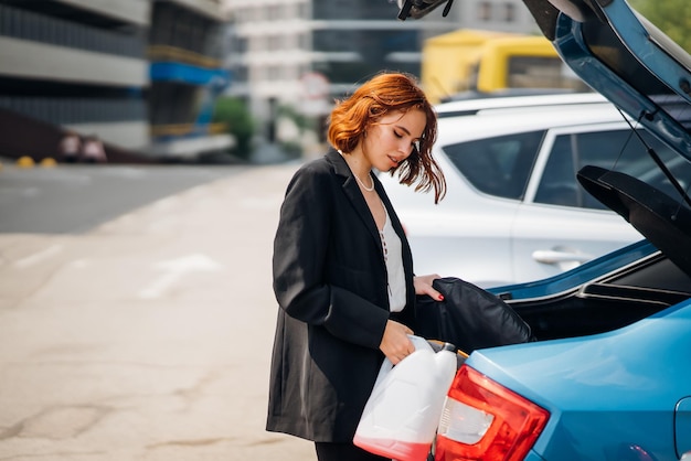 Eine Frau legt Sachen ins Auto