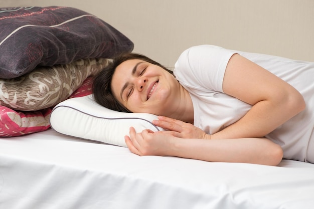 Eine Frau schläft auf einem orthopädischen Kissen aus Memory-Schaum