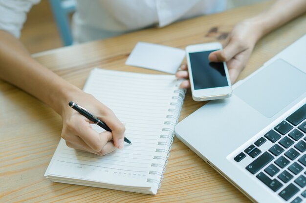 Eine Geschäftsfrau, die an dem Laptop im Büro arbeitet