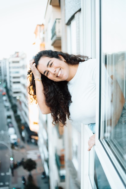 Foto eine glückliche frau, die durch das fenster schaut