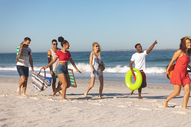 Eine Gruppe von Freunden geht zusammen am Strand spazieren