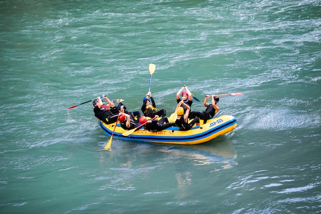 Eine Gruppe von Männern und Frauen raftet auf dem Fluss, Extrem- und Spaßsport