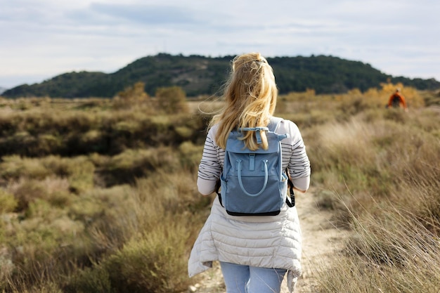 Eine Gruppe von Touristen, die vor dem Hintergrund der Natur in die Berge gehen