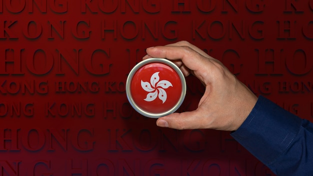 Foto eine hand, die ein abzeichen der nationalflagge von hongkong auf dunkelrotem hintergrund hält