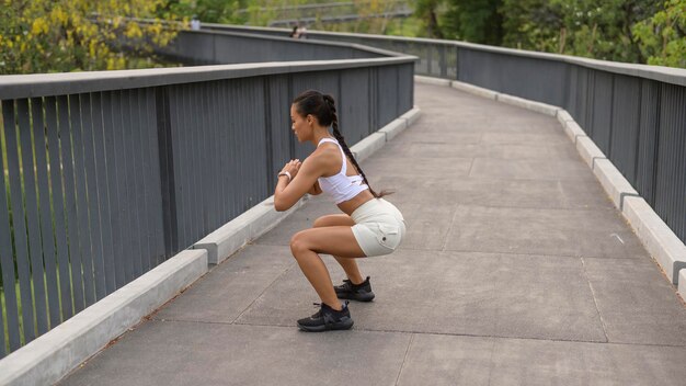 Eine junge Fitnessfrau in Sportbekleidung, die im Stadtpark trainiert Gesund und Lebensstil