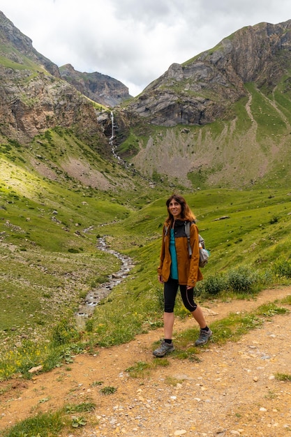 Eine junge Frau neben dem Wasserfall Salto de Tendenera in den Pyrenäen Ripera Valley Panticosa