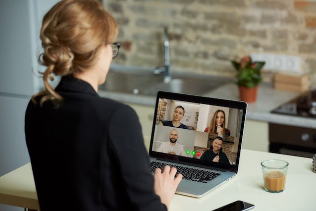 Eine Laptop-Bildschirmansicht über die Schulter einer Frau.