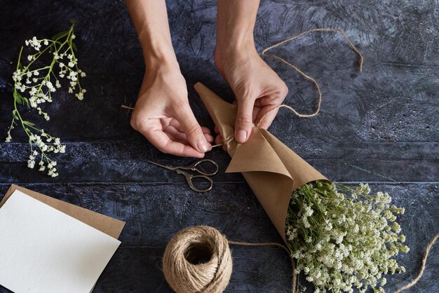 Foto eine mittelgroße frau arbeitet mit getrockneten blumen, montiert komposition, dekor und blumenkonzept