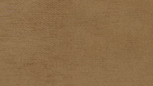 Eine Nahaufnahme einer braunen Oberfläche mit einer Textur, die dem Suede oder Leder ähnelt und sein glattes und weiches Aussehen zeigt