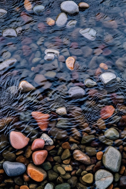 Eine Nahaufnahme von Felsen in einem Fluss mit Wellen im Wasser