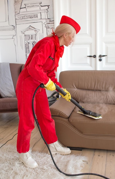 Eine professionelle Reinigungskraft in roter Uniform bei ihrer Arbeit bei einer Dampfmaschinen-Reinigungsfirma