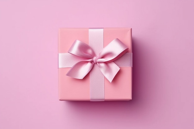 Eine rosa Geschenkbox mit einer rosa Schleife und einer Schleife darauf.