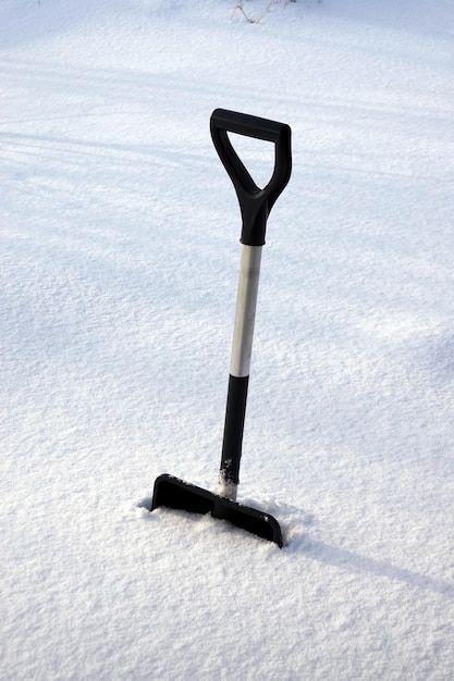 Eine Schneeschaufel im Schnee