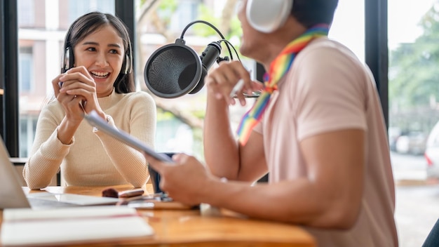 Eine schöne asiatische Podcast-Radiomoderatorin unterhält sich gerne mit ihrer schwulen Kollegin im Studio