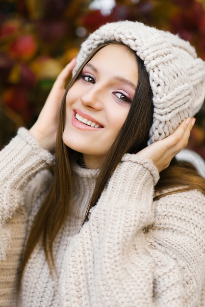 Eine schöne Frau, die im Herbst Strickwaren trägt