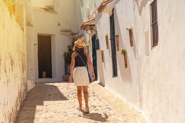 Eine touristische Frau zu Fuß durch die weißen Häuser von Vejer de la Frontera Cadiz Andalusien