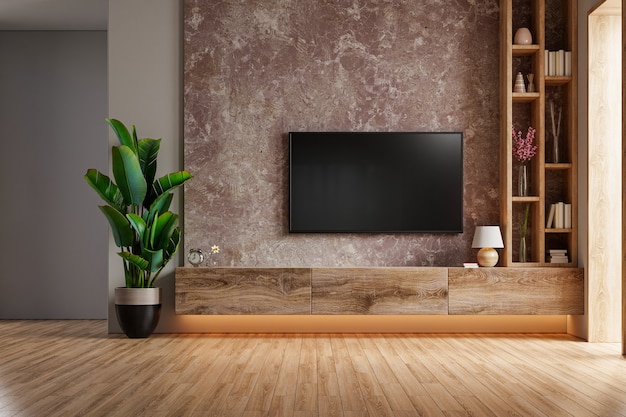 eine TV-Wand, die in einem dunklen Raum mit dunkler Marmorwand montiert ist. 3D-Rendering