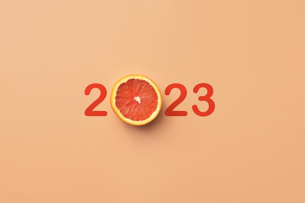 Foto eine ungewöhnliche inschrift 2023 mit einem orangefarbenen a-symbol für das bevorstehende frohe neue jahr