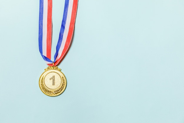 Einfach flacher Design-Gewinner oder Champion-Gold-Trophäe-Medaille einzeln auf blauem, buntem Hintergrund Sieg erster Platz des Wettbewerbs. Gewinn- oder Erfolgskonzept. Kopienraum der Draufsicht.