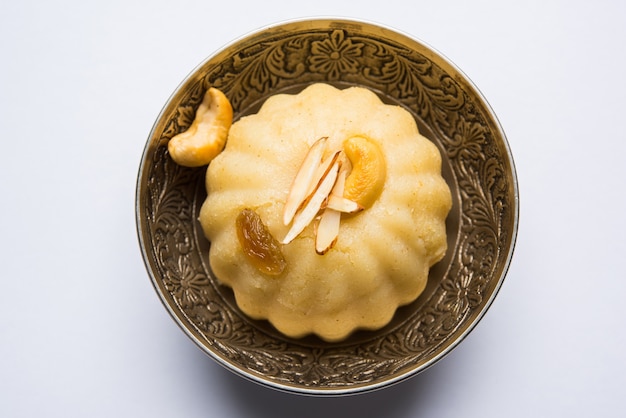 Einfacher oder Safran gewürzter Grieß oder Soji Halwa, auch bekannt als Sweet Rava Sheera ODER Shira - indisches Fest süß garniert mit Trockenfrüchten. Serviert in einem Teller oder einer Schüssel, selektiver Fokus