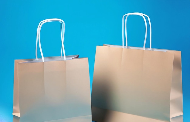 Einkaufstaschen aus Fotopapier auf blauem Hintergrund