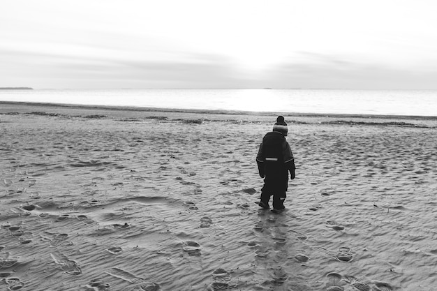 Einsamer Junge an einem einsamen Strand