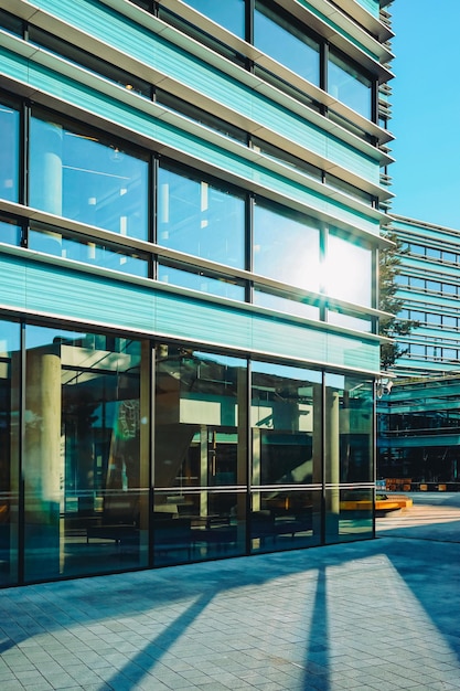 Eintritt in die kommerzielle Architektur eines modernen Wolkenkratzers aus Stahl und Glas, der den blauen Himmel widerspiegelt