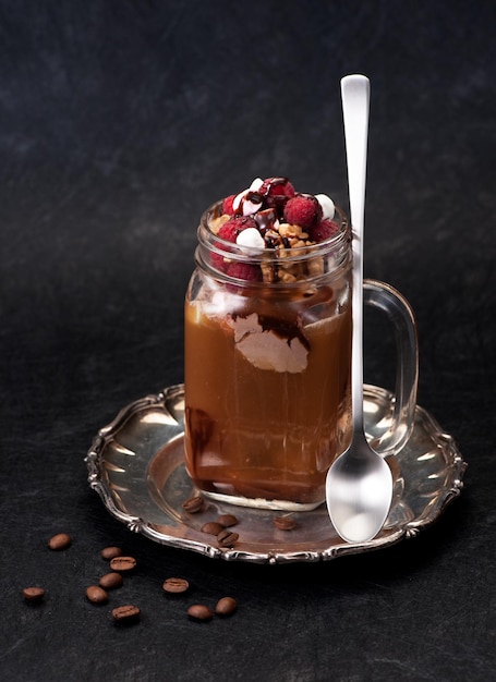 Eiskaffee mit Schokoladeneis und Himbeeren auf Vintage-Platte