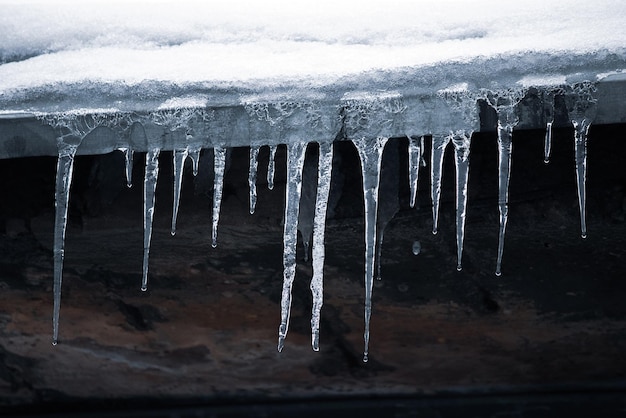 Eiszapfen am Dach Gefährliche Vereisung Eisstalaktiten am Haus Schlechte Wartung von Wohngebäuden im Winter