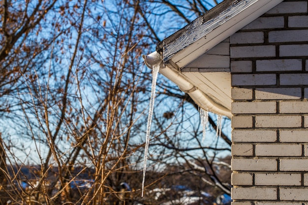 Eiszapfen auf den Dächern von Häusern