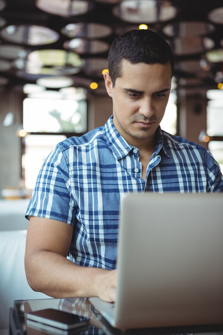 Foto ejecutivo con laptop en cafetería