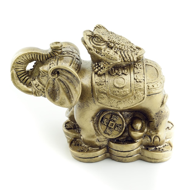Elefante de bronce y una rana sobre un fondo blanco.